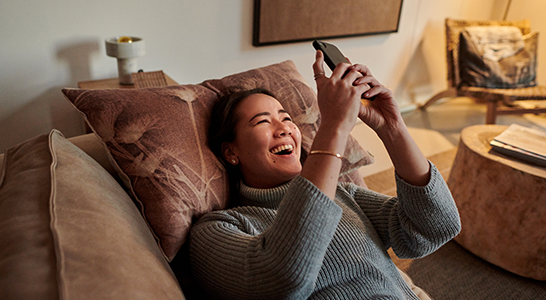 A happy lady enjoying Unifi VoWiFi service